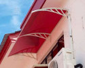 Mr. Gaddafi chose red solid roof polycarbonate sheet canopy for his local customers’ house. 